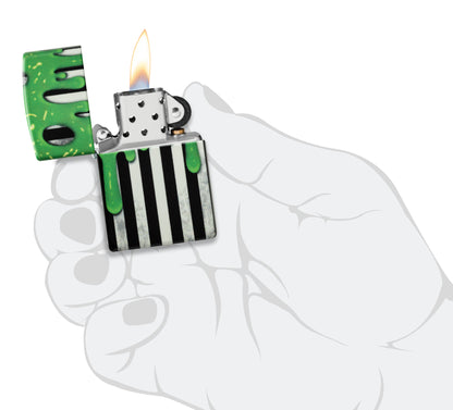 Zippo Glowing Goo Design Glow-in-the-Dark Green Windproof Lighter lit in hand.