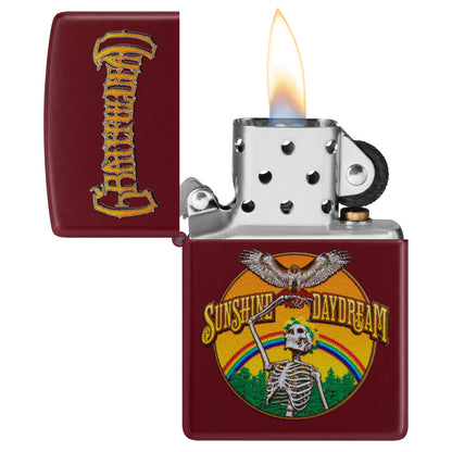 Zippo Grateful Dead Sunshine Daydream Design Merlot Windproof Lighter with its lid open and lit.