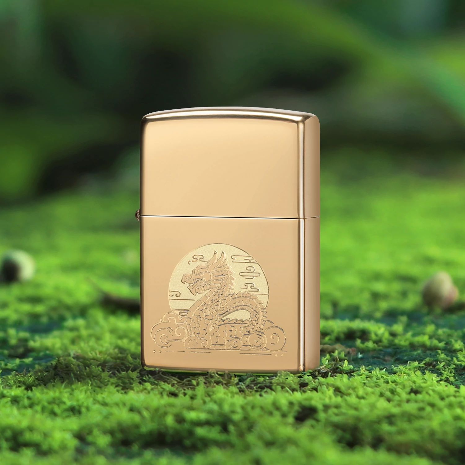 Lifestyle image of Zippo Moon Dragon Design High Polish Brass Windproof Lighter standing on moss-covered ground while showing the front of the lighter. 

