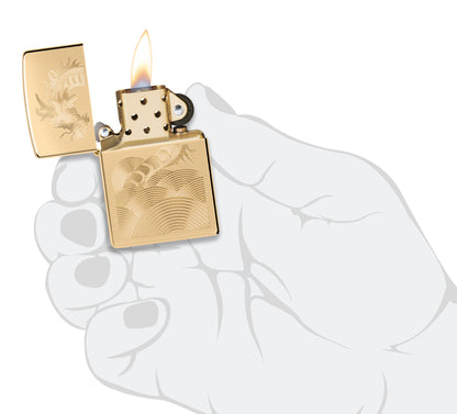 Zippo Golden Dragon Design High Polish Brass Windproof Lighter lit in hand.