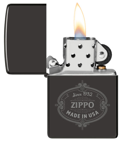 Zippo Plaque Design High Polish Black Windproof Lighter with its lid open and lit.