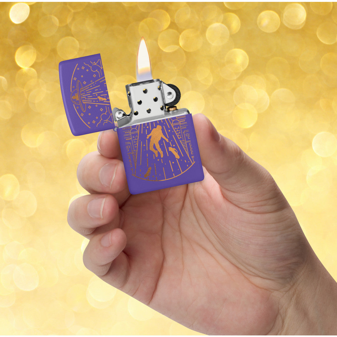 Zippo Beam Me Up Design Purple Matte Windproof Lighter lit in hand.