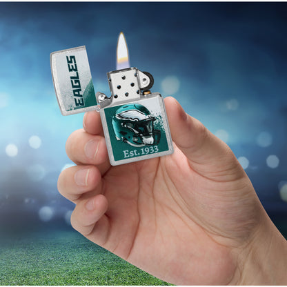 Zippo NFL Philadelphia Eagles Helmet Design Street Chrome Windproof Lighter lit in hand.