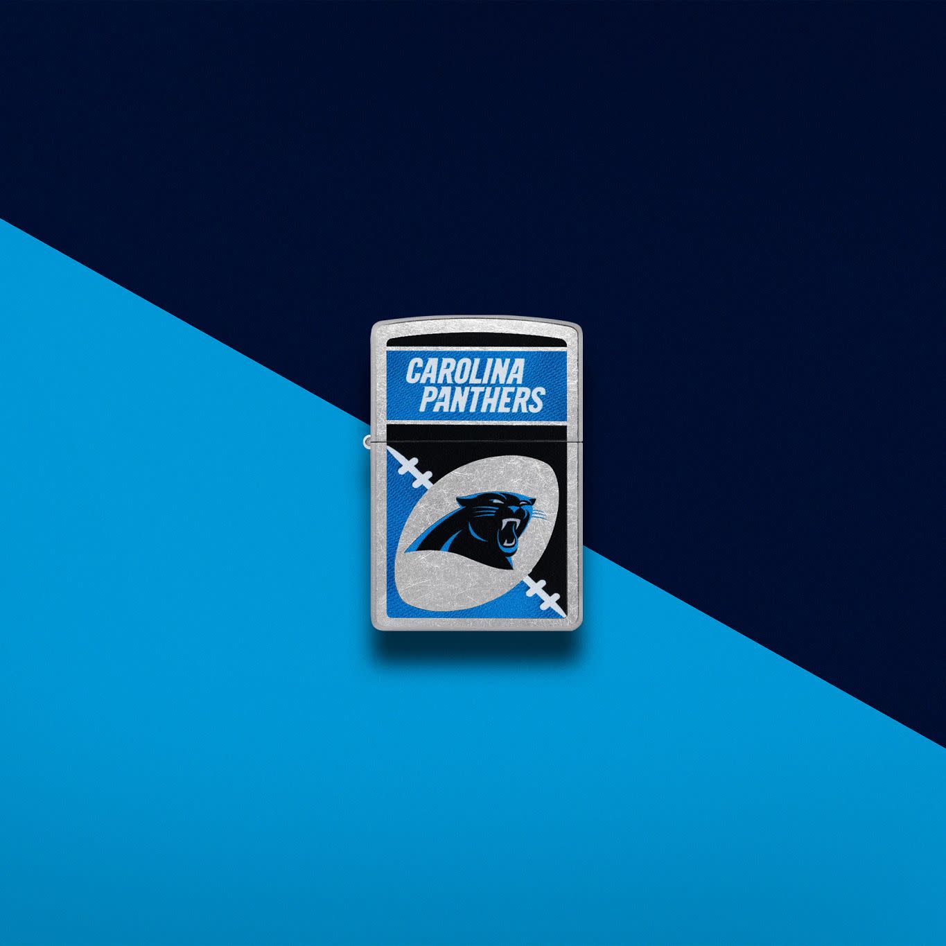 Lifestyle image of Zippo NFL Carolina Panthers Street Chrome Windproof Lighter set on a blue and black background.