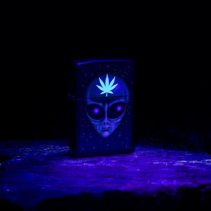 Lifestyle image of Zippo Alien Leaf Design Black Matte Windproof Lighter glowing under a black light.