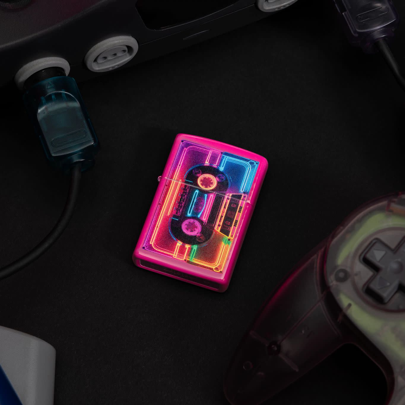 Lifestyle image of Zippo Neon Cassette Design Frequency Windproof Lighter surrounded by retro gaming system items.