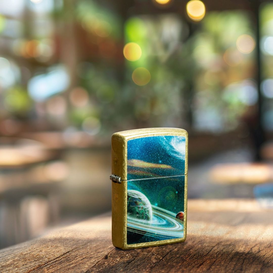 Lifestyle image of Zippo Space Rings Design Street Brass Windproof Lighter standing on a wooden surface showing the front and hinge side of the lighter with an out of focus restaurant as the background. 

