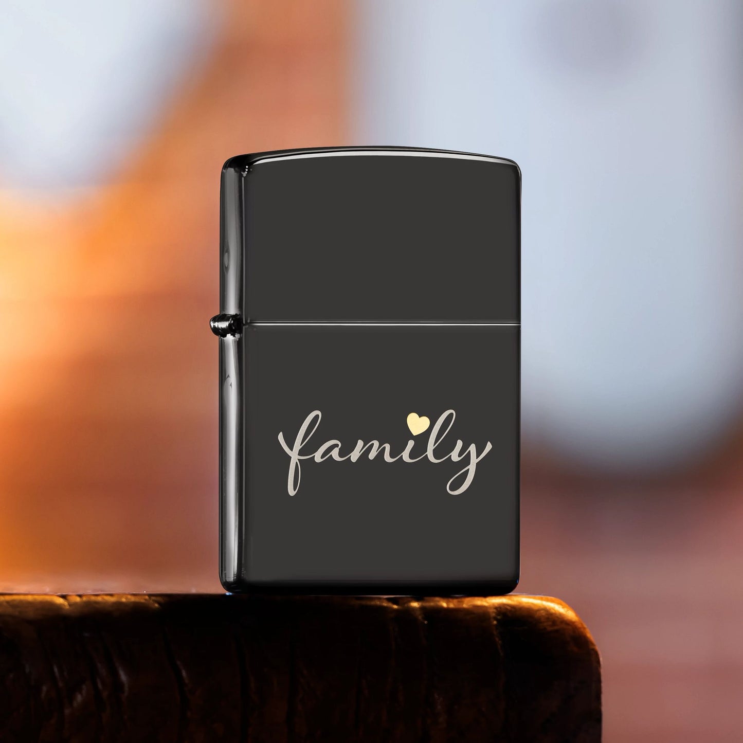 Lifestyle image of Zippo Family Design High Polish Black Windproof Lighter standing on the corner of a bar showing the front of the lighter. 

