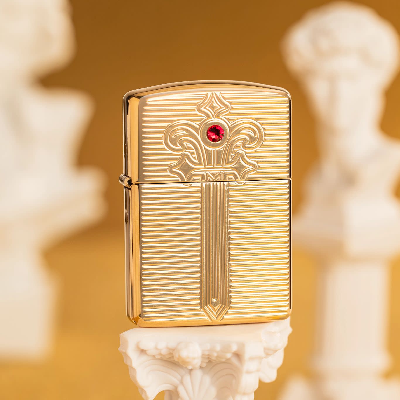 Lifestyle image of Zippo Royal Saber Design ArmorÂ® High Polish Brass Windproof Lighter standing on a pedestal with sculptures in the background.