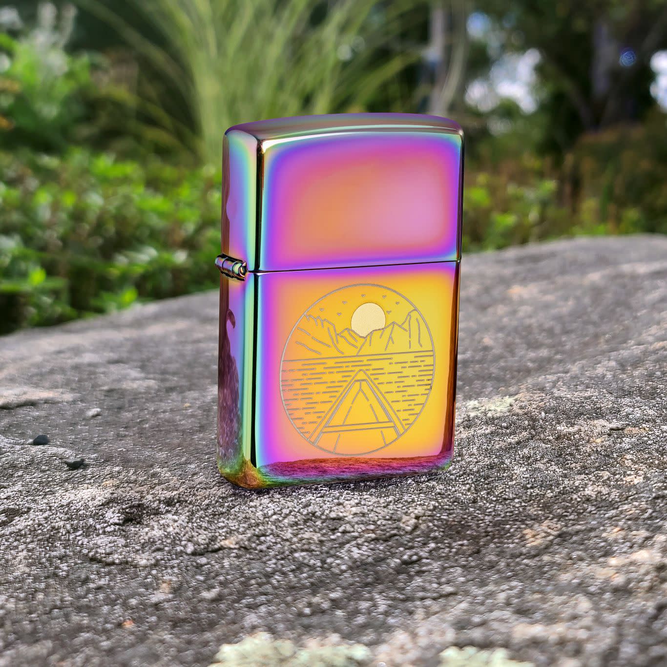 Lifestyle image of Zippo Moon Canoe Design Multi Color Windproof Lighter standing on a rock with greenery in the background.