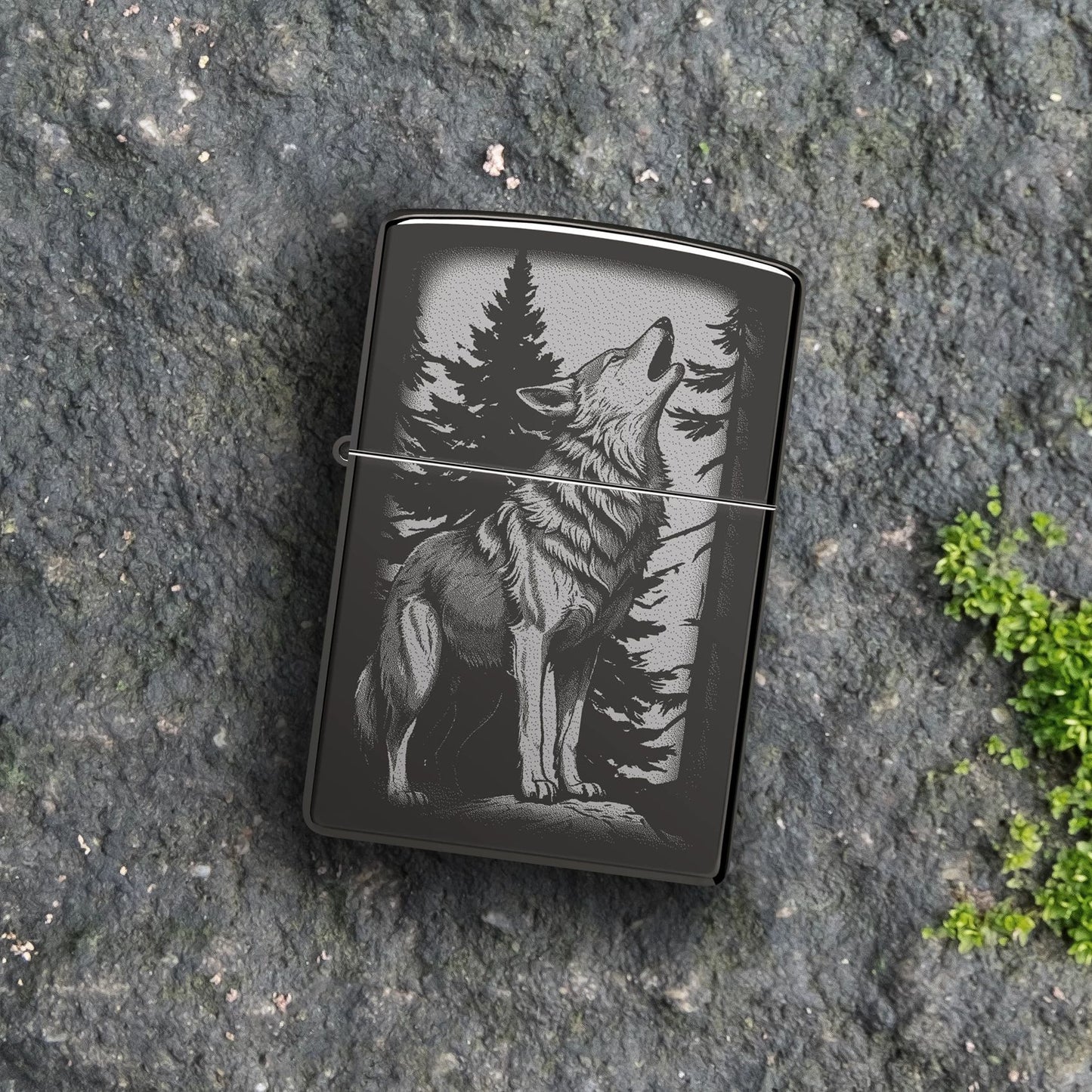 Lifestyle image of Zippo Howling Wolf Design High Polish Black Windproof Lighter lying on a flat rocky surface showing the front of the lighter. 

