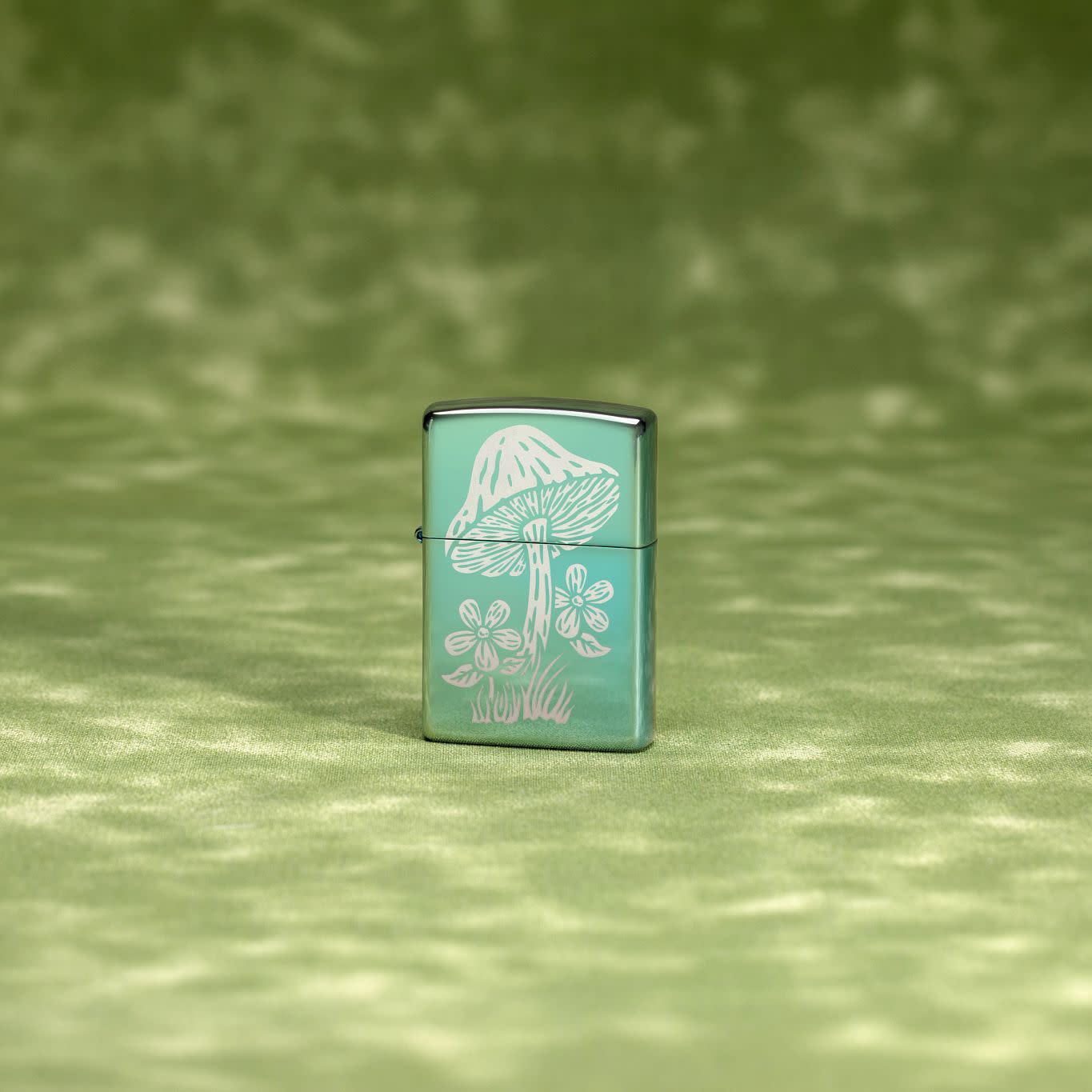 Lifestyle image of Zippo Mushroom Design High Polish Green Windproof Lighter on a textured green background.