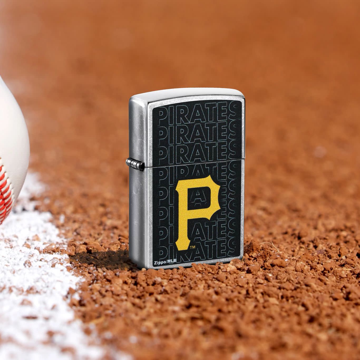 Lifestyle image of Zippo MLB® Pittsburgh Pirates Street Chrome Windproof Lighter standing in the dirt on a baseball field.