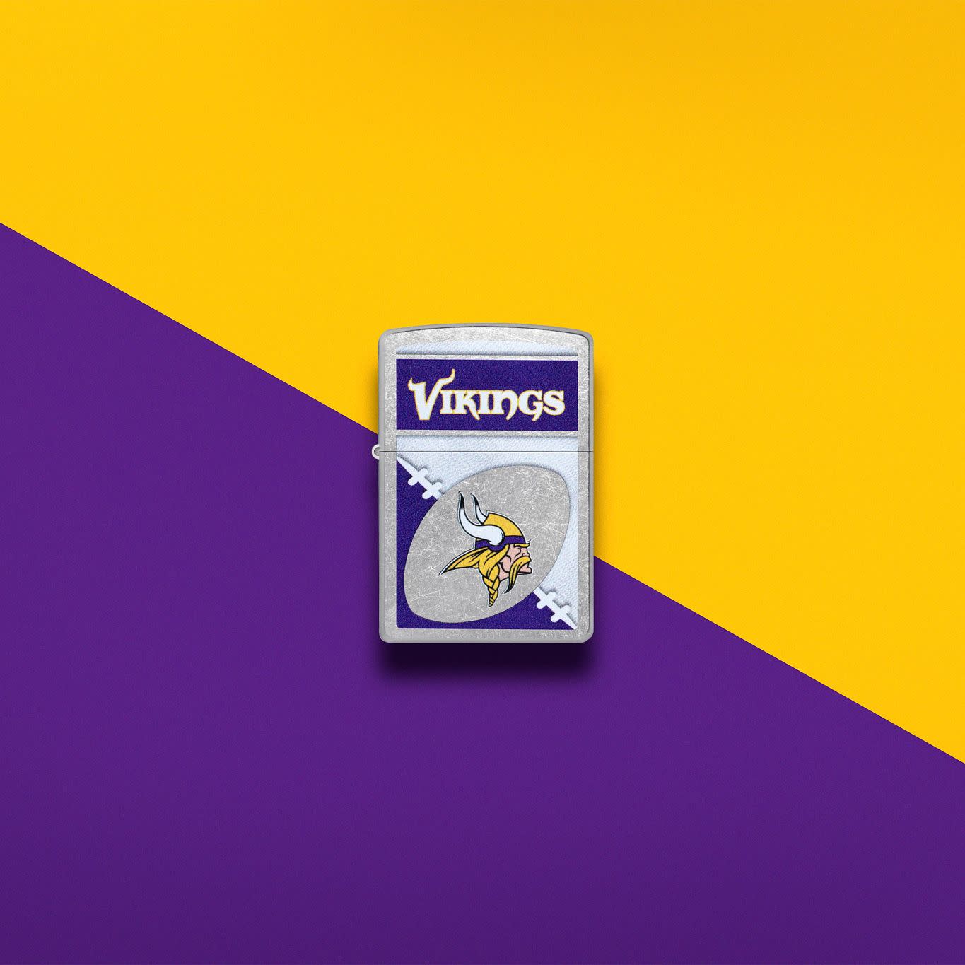 Lifestyle image of Zippo NFL Minnesota Vikings Street Chrome Windproof Lighter set on a purple and gold background.