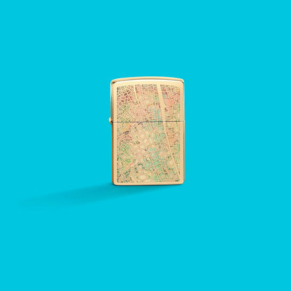 Lifestyle image of Zippo Dragonfly Wing Design High Polish Brass Windproof Lighter on an aqua blue background.