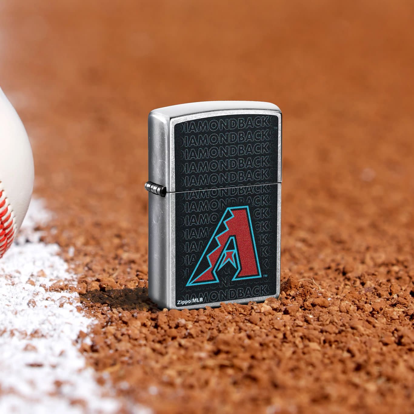 Lifestyle image of Zippo MLB® Arizona Diamondbacks Street Chrome Windproof Lighter standing in the dirt on a baseball field.