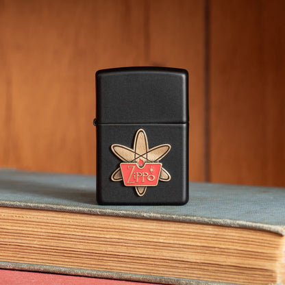 Lifestyle image of Zippo Atomic Zippo Design Black Matte Windproof Lighter standing on a book.