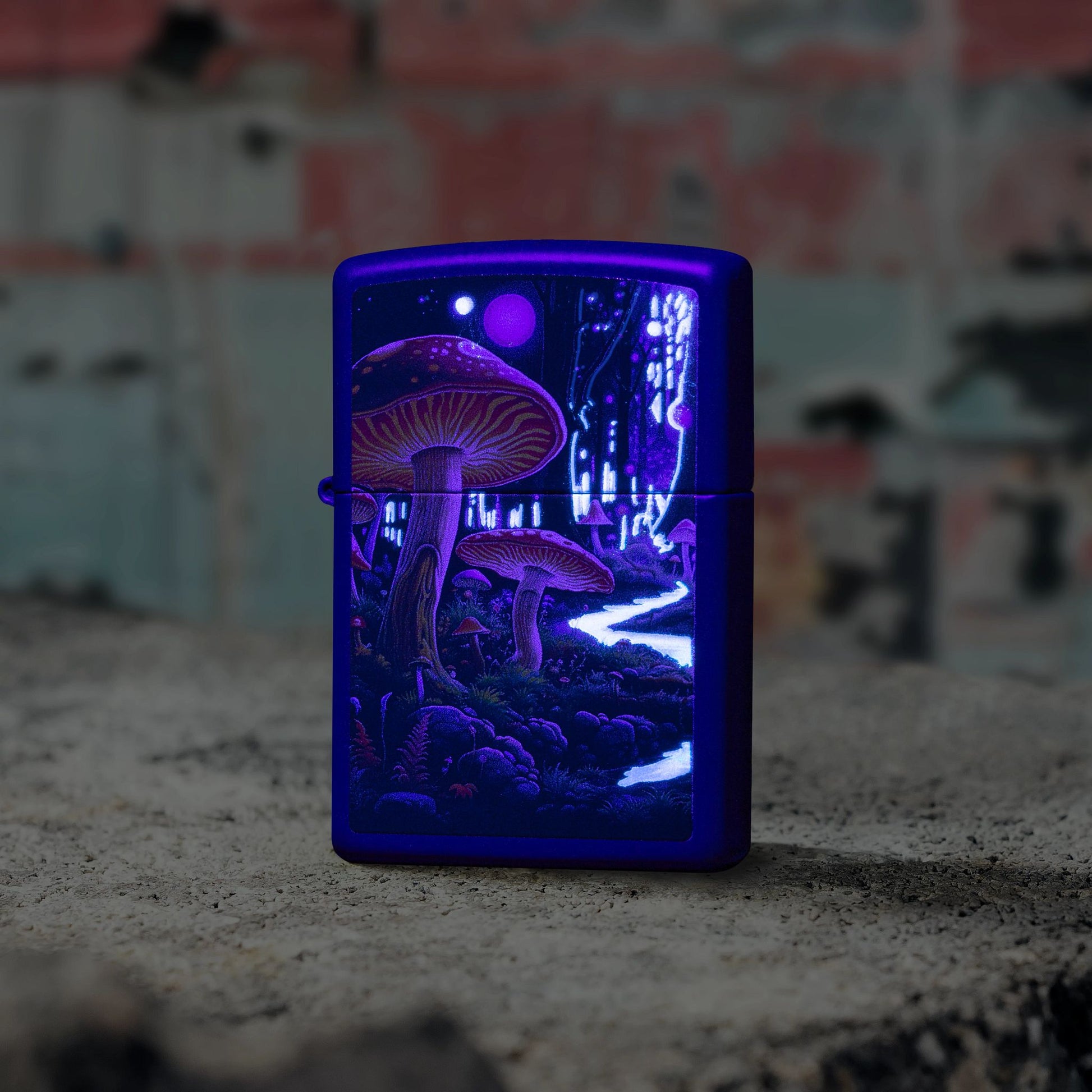 Lifestyle image of Zippo Black Light Mushroom Design Navy Matte Windproof Lighter standing on concrete in front of a graffiti covered wall showing the front of the lighter, while glowing under a black light. 

