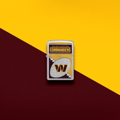 Lifestyle image of Zippo NFL Washington Commanders Street Chrome Windproof Lighter set on a burgundy and yellow background.