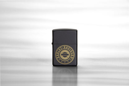 Lifestyle image of Harley-Davidson® Laser Engrave Logo Black Matte Lighter, standing on a reflective sheet of metal