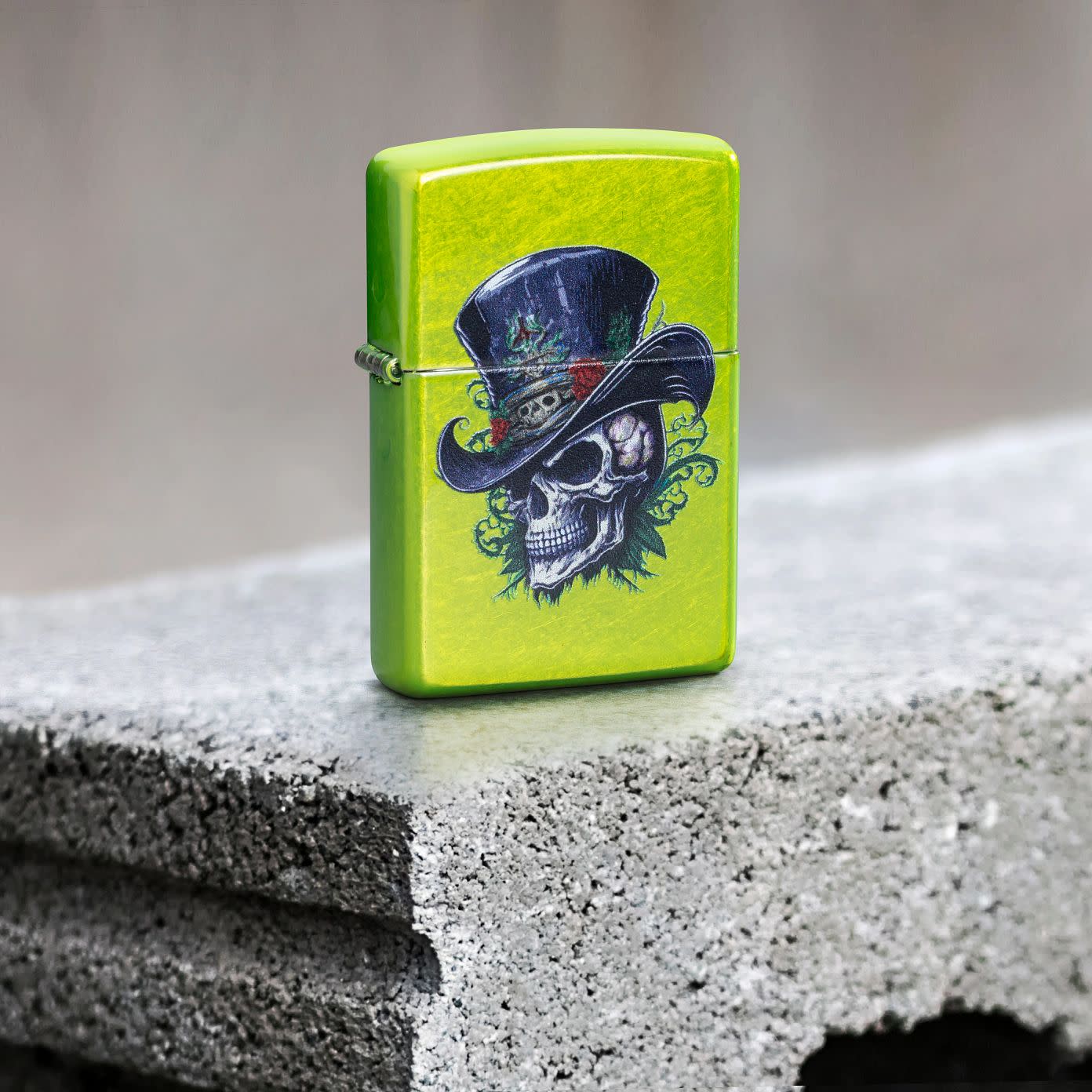 Lifestyle image of Zippo Steampunk Skeleton Design Lurid Windproof Lighter standing on a cement block.