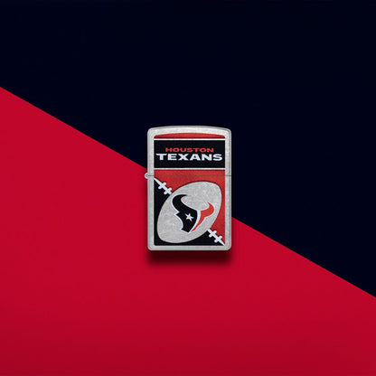 Lifestyle image of Zippo NFL Houston Texans Street Chrome Windproof Lighter set on a red and black background.