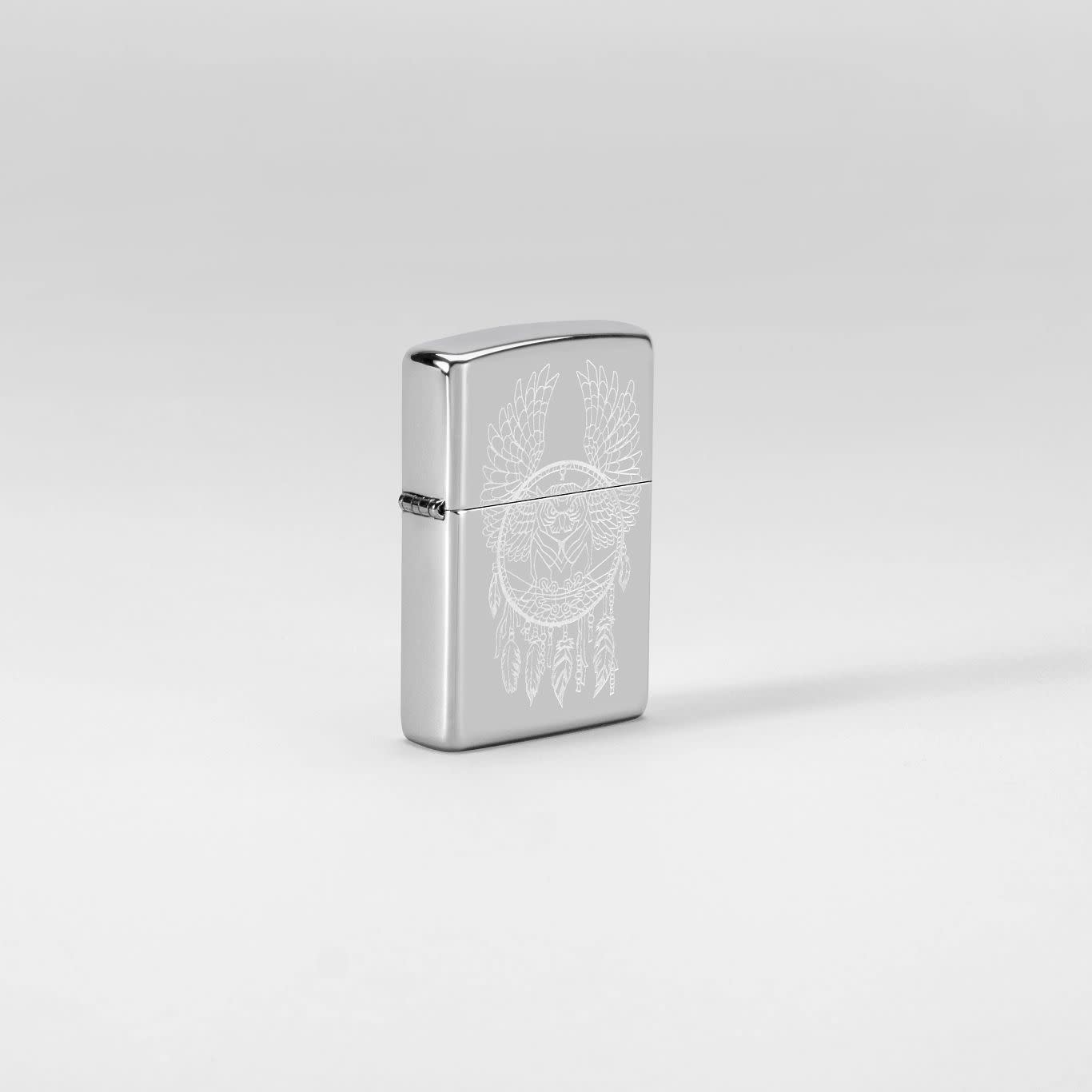 Glamour shot of Zippo Dreamcatcher Design High Polish Chrome Windproof Lighter standing in a white scene.