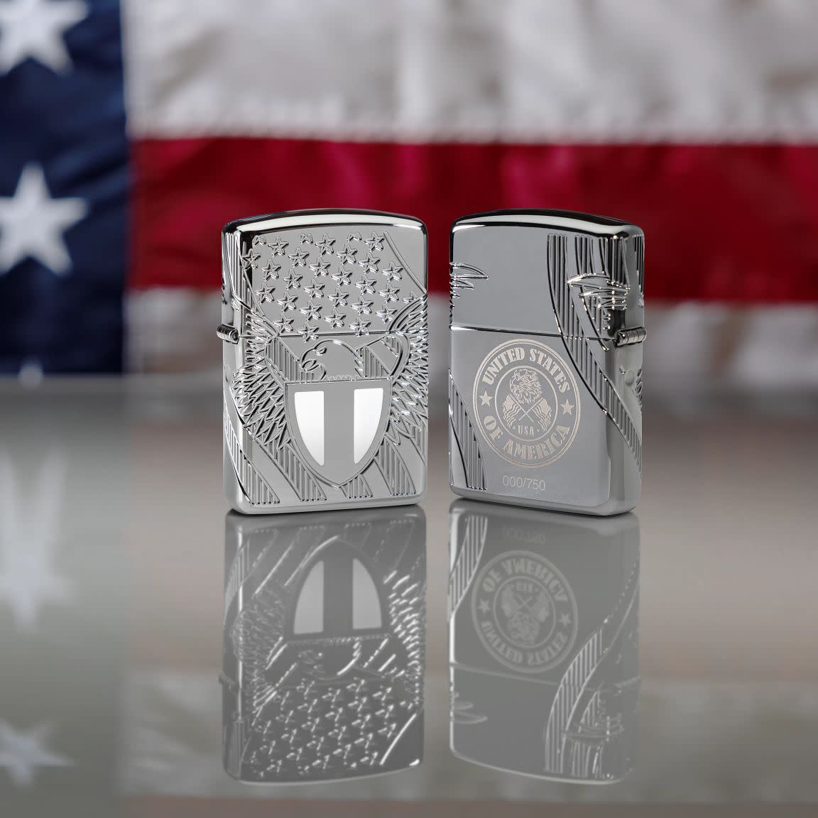 Lifestyle image of two Zippo Liberty Crest Collectible Armor® High Polish Chrome Windproof Lighters standing in front of a flag background.