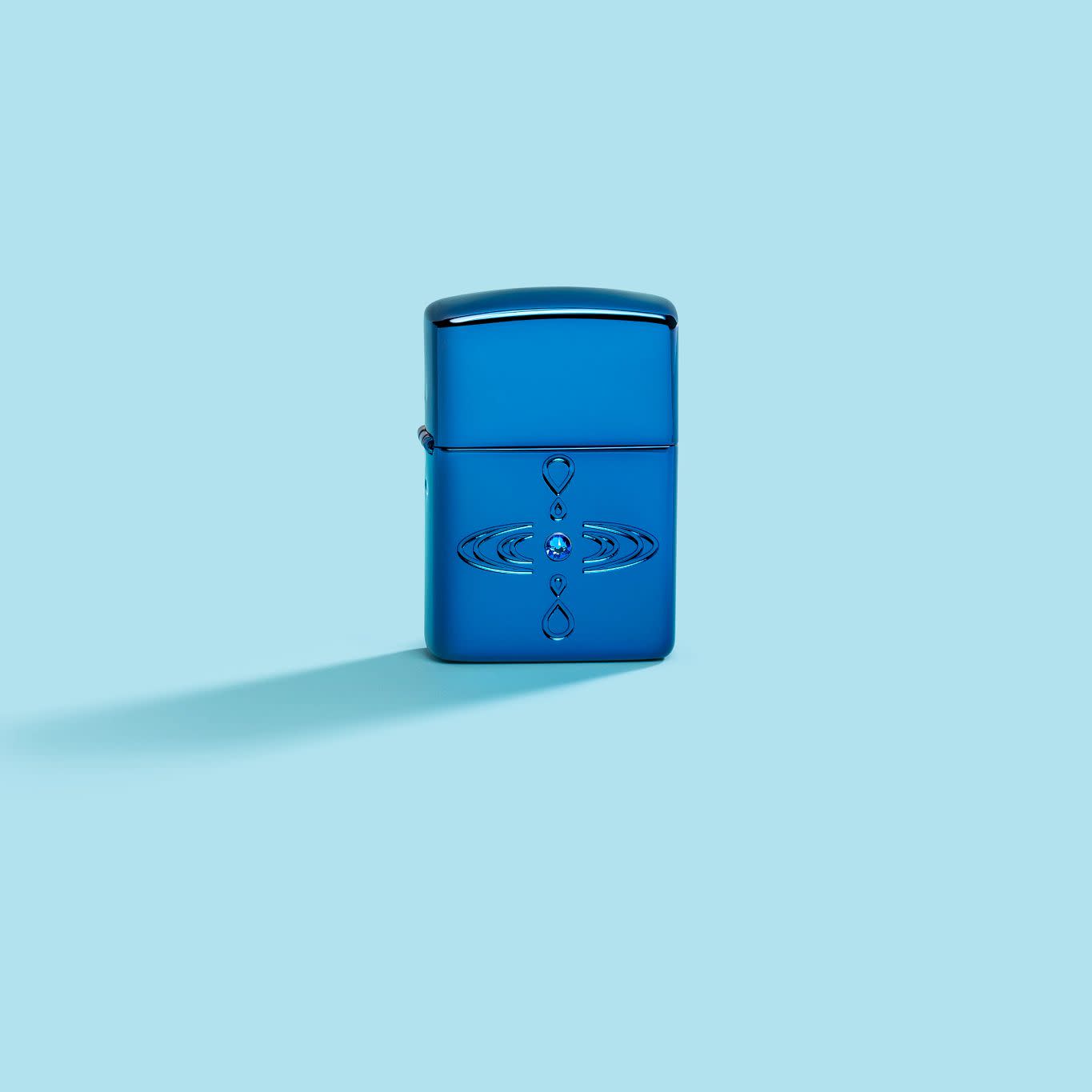 Lifestyle image of Zippo Simple Design Armor High Polish Blue Windproof Lighter on a pastel blue background.