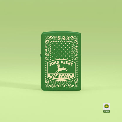 Lifestyle image of Zippo John Deere Paisley Design Moss Green Windproof Lighter standing with a light green background.


