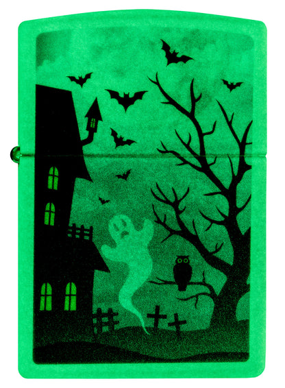 Front view of Zippo Spooky Design Glow in the Dark Green Windproof Lighter glowing in the dark.