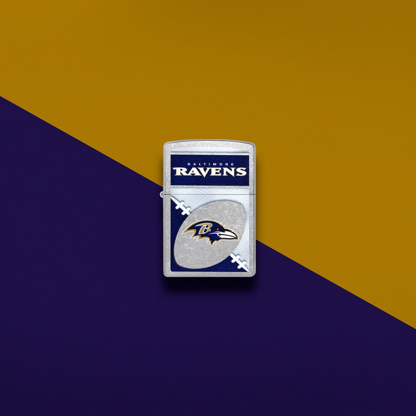 Lifestyle image of Zippo NFL Baltimore Ravens Street Chrome Windproof Lighter set on a purple and gold background.