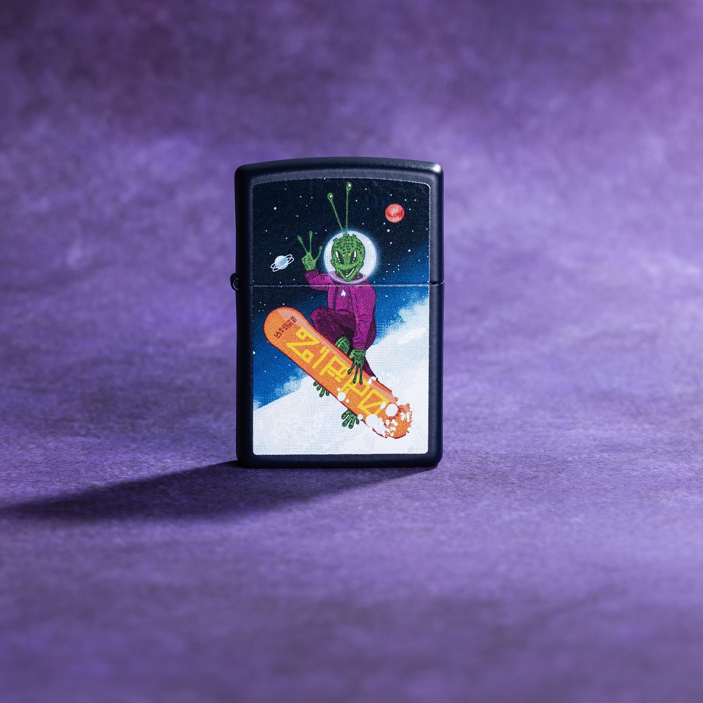 Lifestyle image of Zippo Space Shredder Design Navy Matte Windproof Lighter standing with a purple background. 

