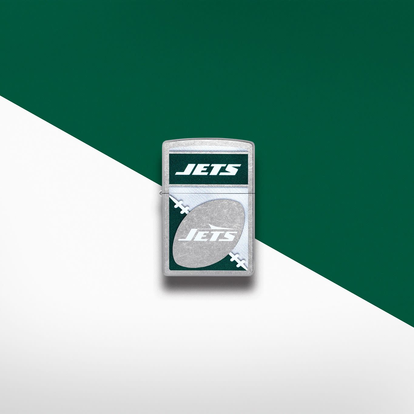 Lifestyle image of Zippo NFL New York Jets Street Chrome Windproof Lighter set on a silver and green background.