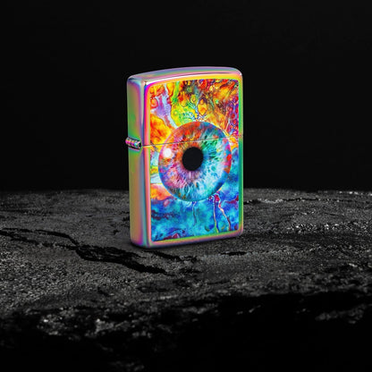 Lifestyle image of Zippo Spacey Eye Design Multi Color Windproof Lighter standing on a black rock on a black background.