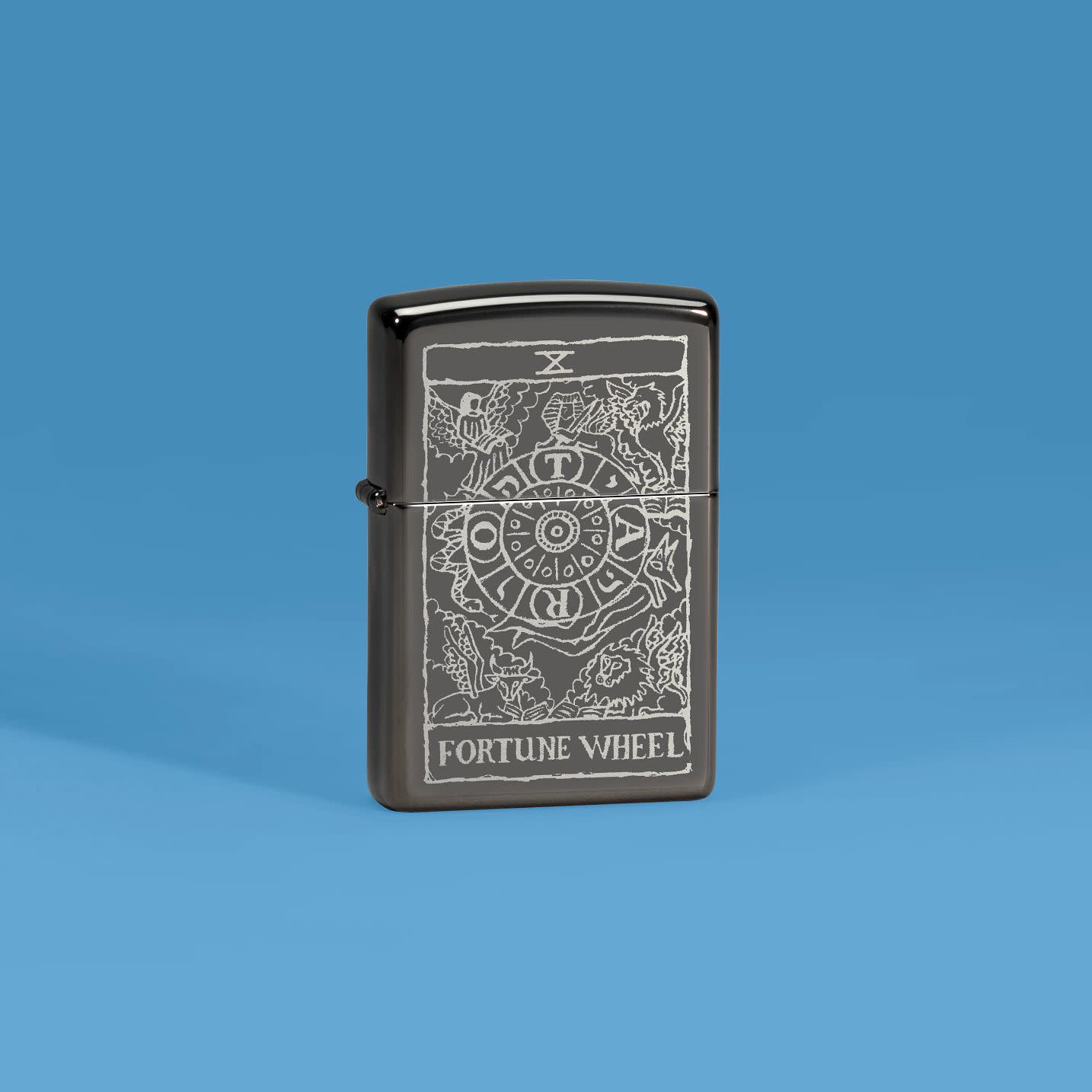 Lifestyle image of Zippo Wheel of Fortune Design High Polish Black Windproof Lighter on a medium blue background.