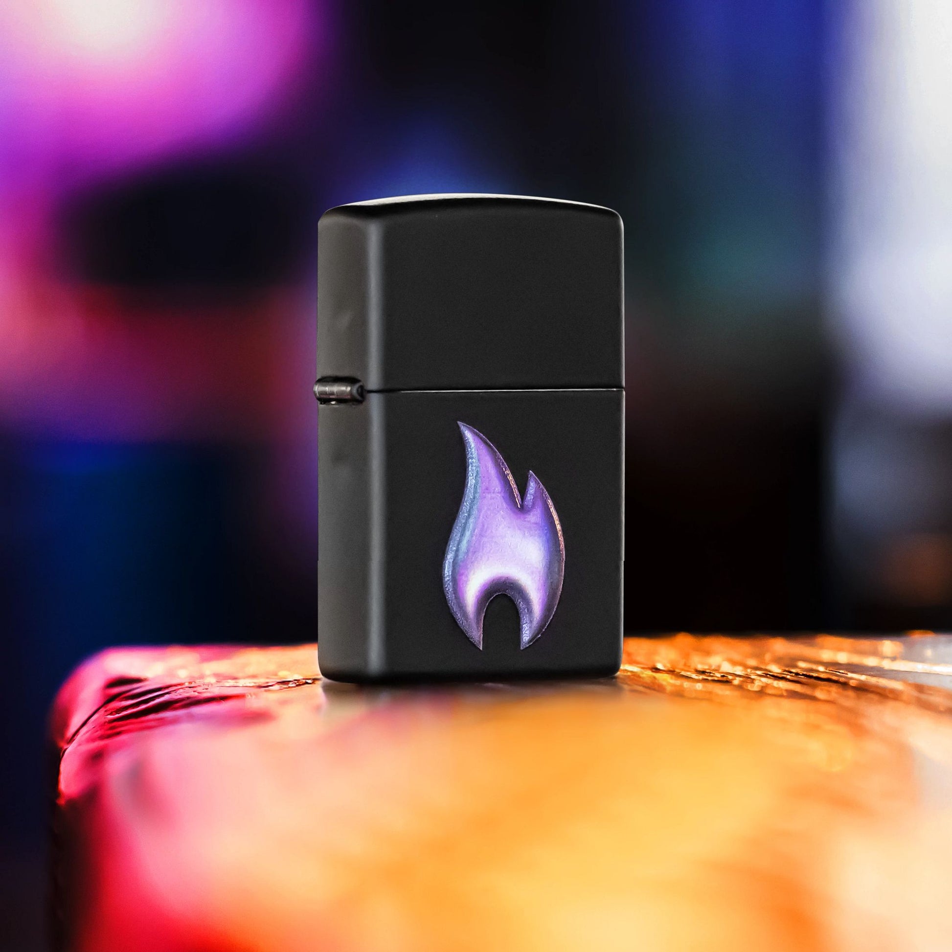 Lifestyle image of Zippo Texture Flame Design Black Matte Windproof Lighter standing on the corner of a rustic bar showing the front and hinge side of the lighter. 

