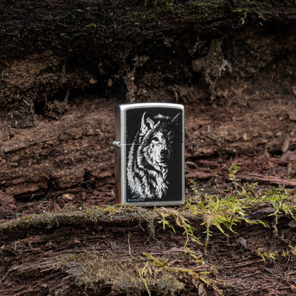 Lifestyle image of Zippo Lindsay Kivi Shadow Wolf Street Chrome Windproof Lighter standing on a mossy outdoor background.