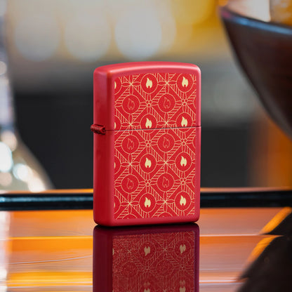Lifestyle image of Zippo Festive Flame Design Red Matte Windproof Lighter standing on a bar showing the front and hinge side of the lighter. 

