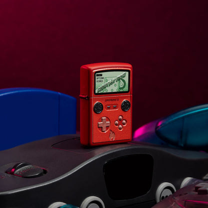 Lifestyle image of Zippotronic Design Red Matte Windproof Lighter standing on a retro gaming system.