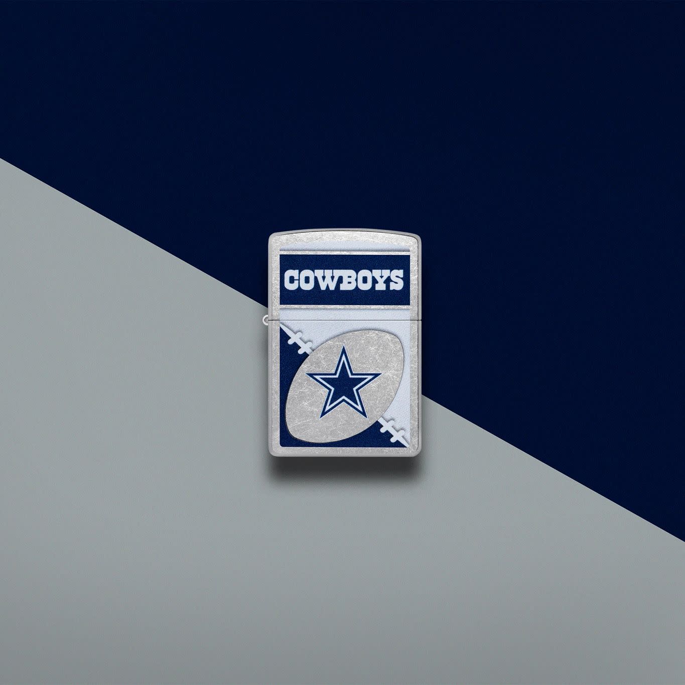 Lifestyle image of Zippo NFL Dallas Cowboys Street Chrome Windproof Lighter set on a navy and light gray background.