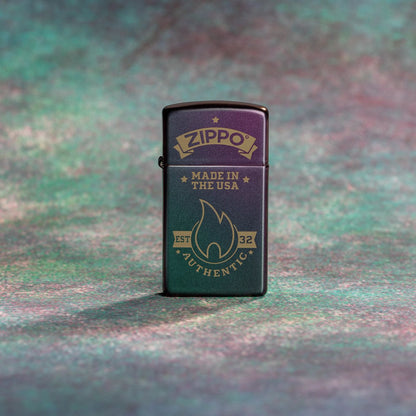 Lifestyle image of Zippo Authentic Zippo Design Slim Iridescent Windproof Lighter standing with a purple, teal, and grey background. 


