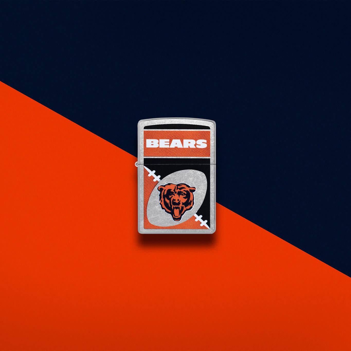 Lifestyle image of Zippo NFL Chicago Bears Street Chrome Windproof Lighter set on an orange and navy background.