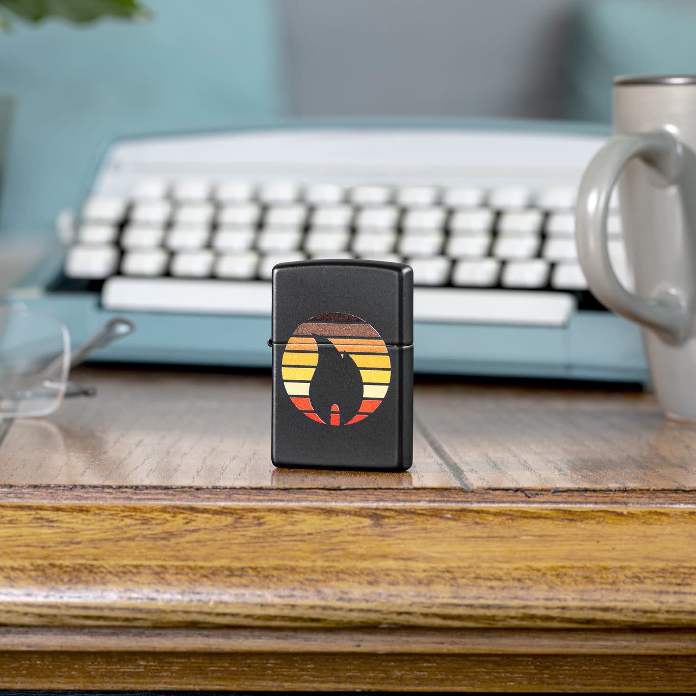 Lifestyle image of Zippo Colorblock Zippo Design Black Matte Windproof Lighter standing on a desk in front of a typewriter.