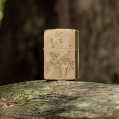 Lifestyle image of Zippo Golden Dragon Design High Polish Brass Windproof Lighter standing on a moss-kissed limb with a blurred tree trunk as the background.

