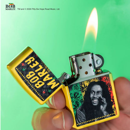 Lifestyle image of Zippo Bob Marley Sunshine Design Classic Sunflower Windproof Lighter lit in hand showing the front of the lighter, with a light green background.