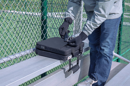 Lifestyle image of Zippo Heated Seat - Double with a man plugging in the HeatBank® 9s (included).