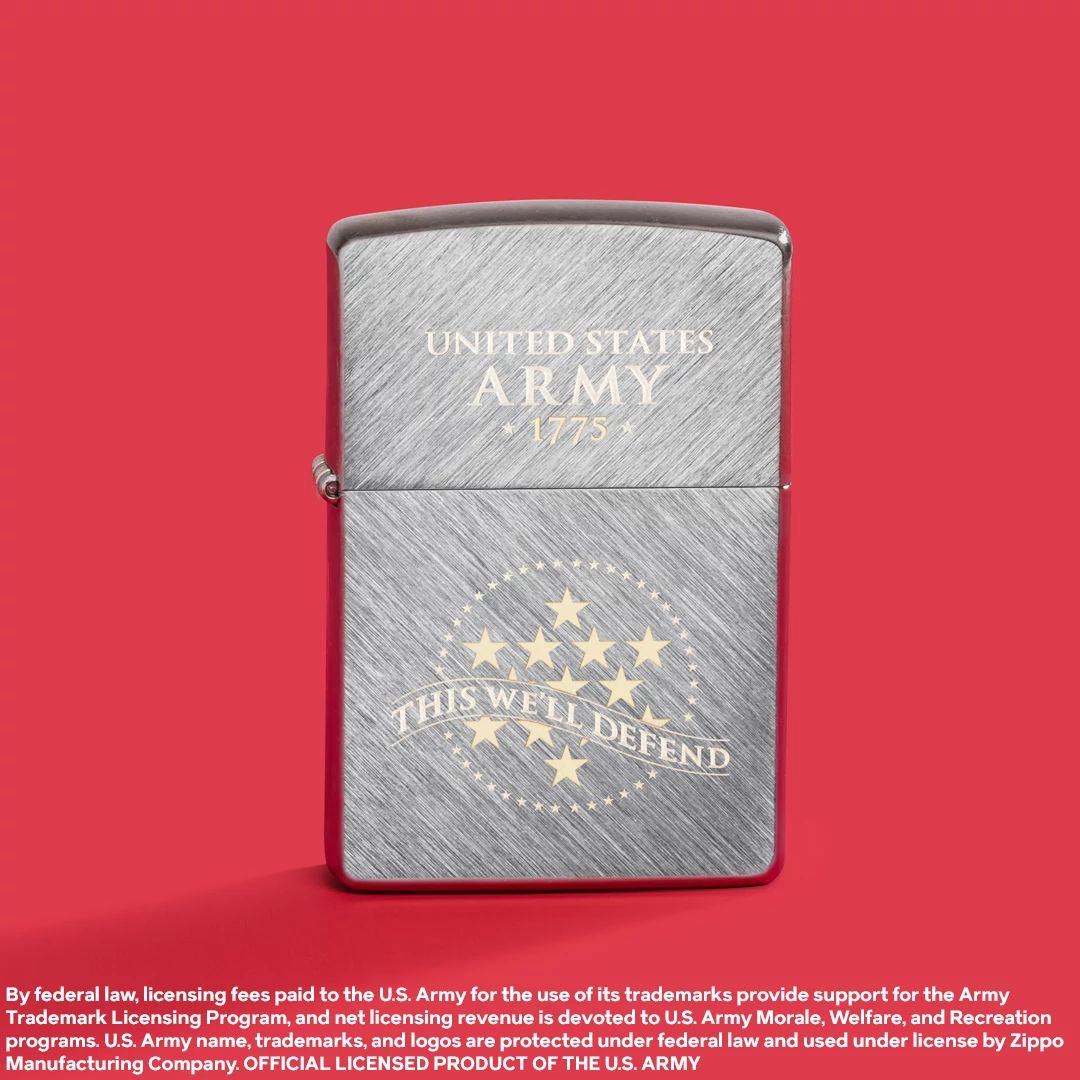 Lifestyle image of Zippo U.S. Army® This We'll Defend Design Herringbone Sweep Windproof Lighter standing while showing the front of the lighter with a red background.

