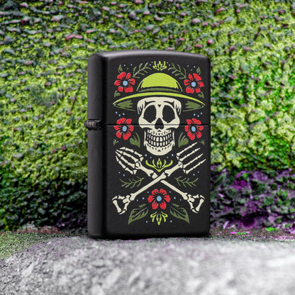 Lifestyle image of Zippo Garden for Life Design Black Matte Windproof Lighter standing on a concrete step next to graffiti wall art showing the front of the lighter.