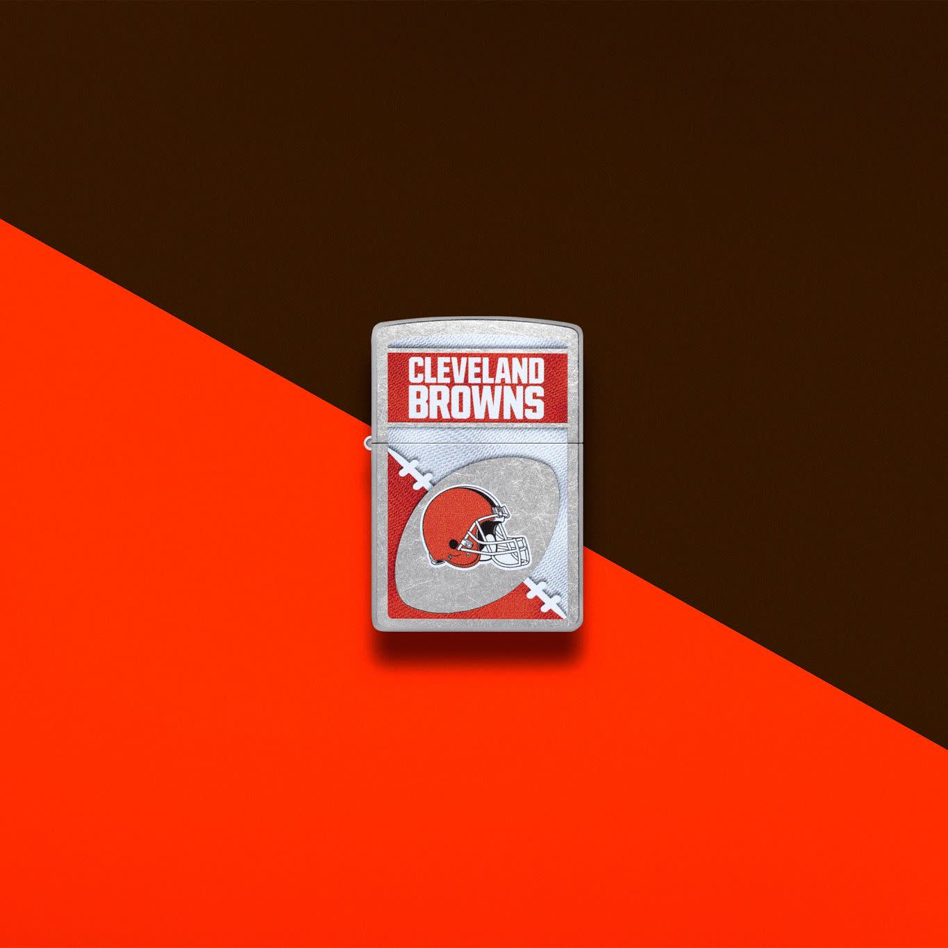 Lifestyle image of Zippo NFL Cleveland Browns Street Chrome Windproof Lighter set on an orange and brown background.